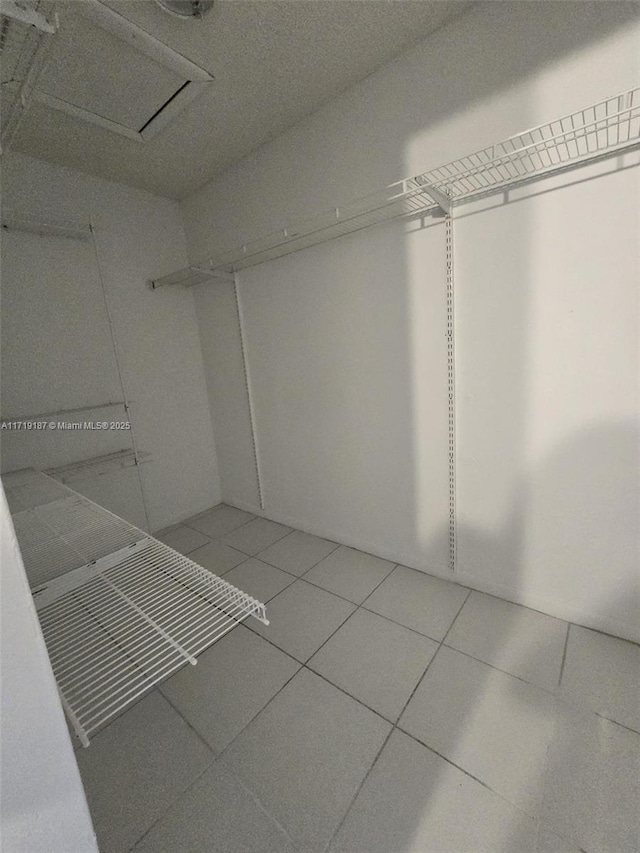 walk in closet featuring tile patterned flooring