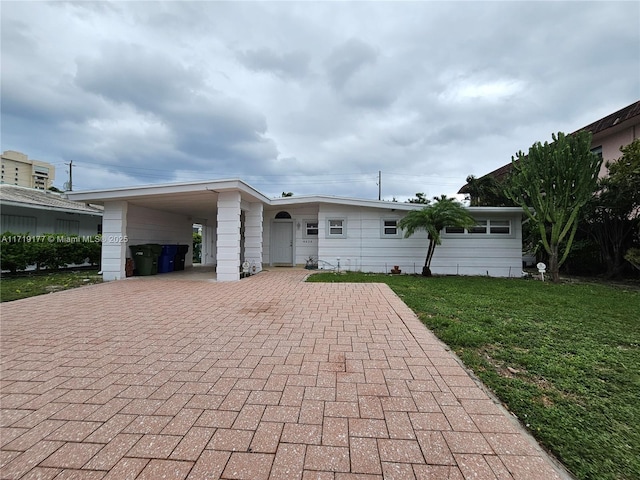 back of house featuring a yard and a carport