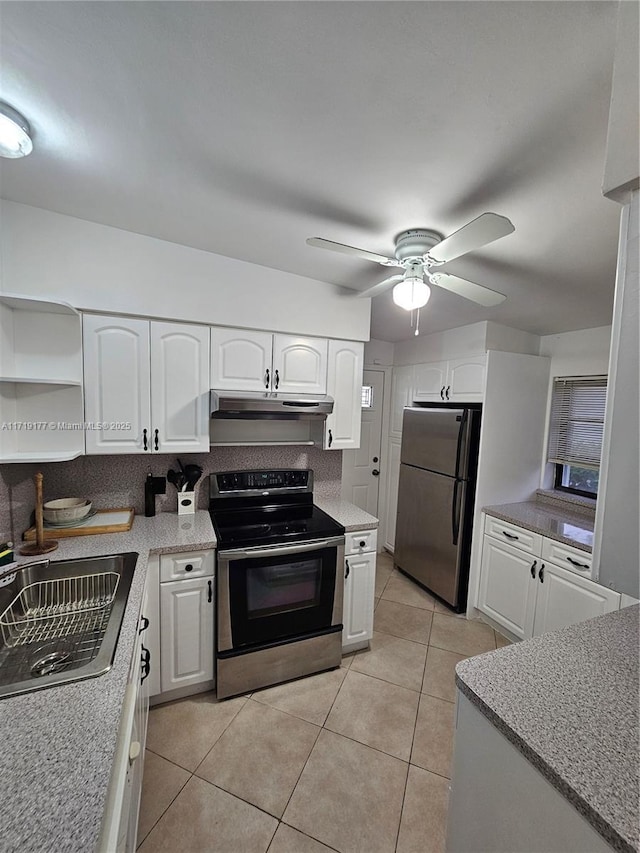 kitchen featuring ceiling fan, sink, light tile patterned flooring, white cabinets, and appliances with stainless steel finishes