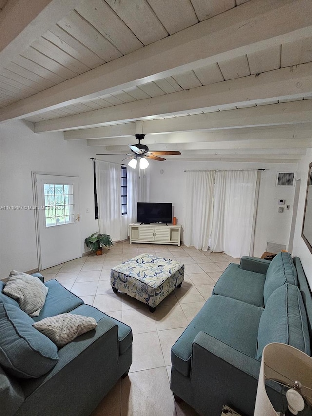 tiled living room featuring ceiling fan and beamed ceiling