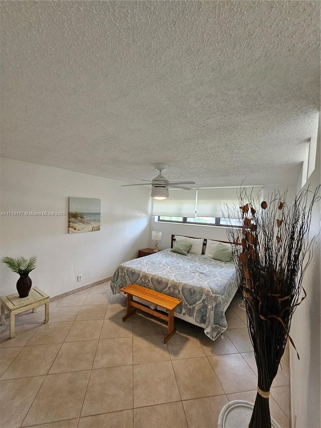 bedroom featuring ceiling fan and light tile patterned flooring