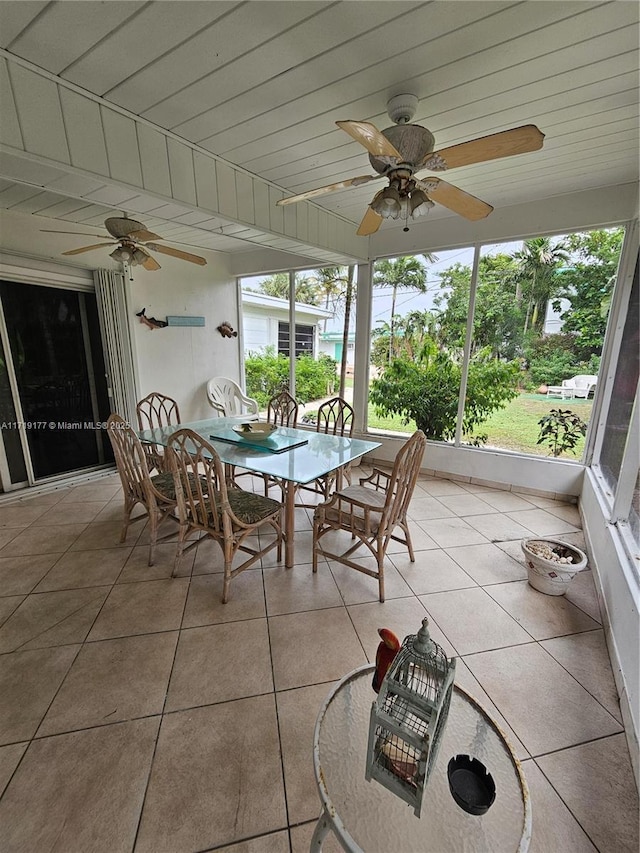 unfurnished sunroom with ceiling fan