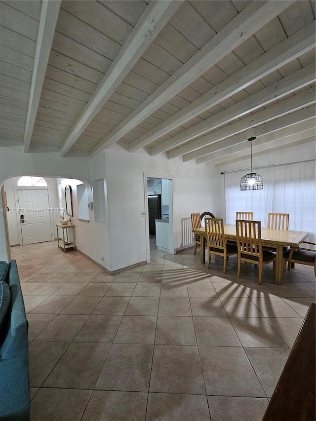 dining area featuring beam ceiling