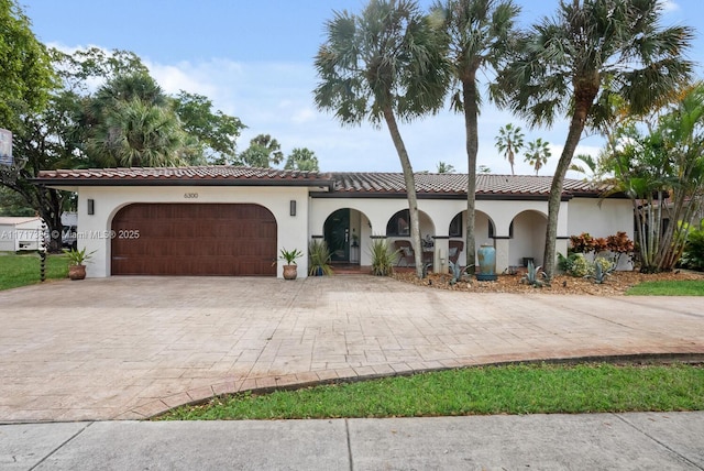 mediterranean / spanish home with a garage