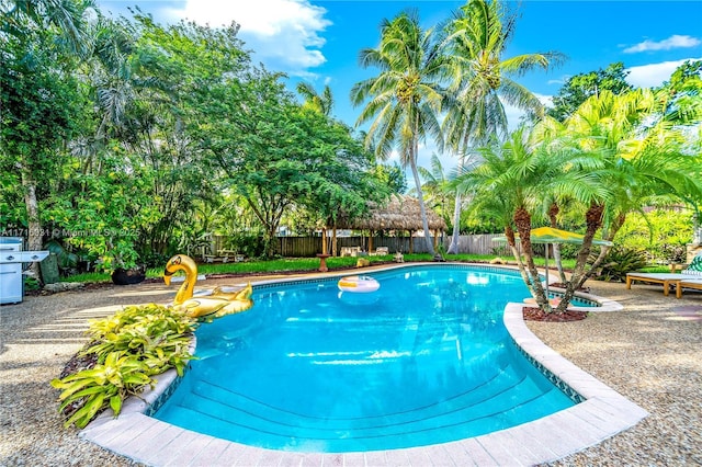 view of swimming pool featuring a fenced backyard, a fenced in pool, and a patio