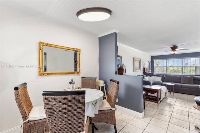 dining room with ceiling fan, light tile patterned floors, a textured ceiling, and ornamental molding