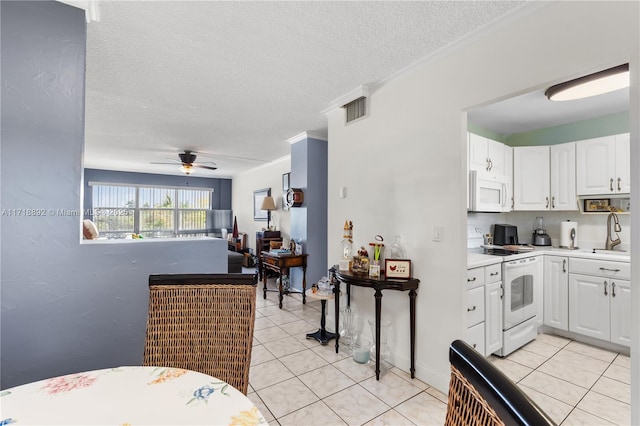 kitchen with ceiling fan, white cabinetry, white appliances, and light tile patterned floors