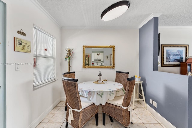 dining room featuring light tile patterned floors, a textured ceiling, and ornamental molding