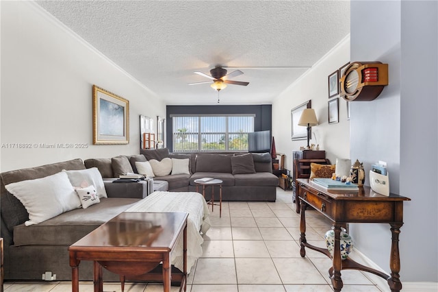 living room with ceiling fan, light tile patterned flooring, and a textured ceiling