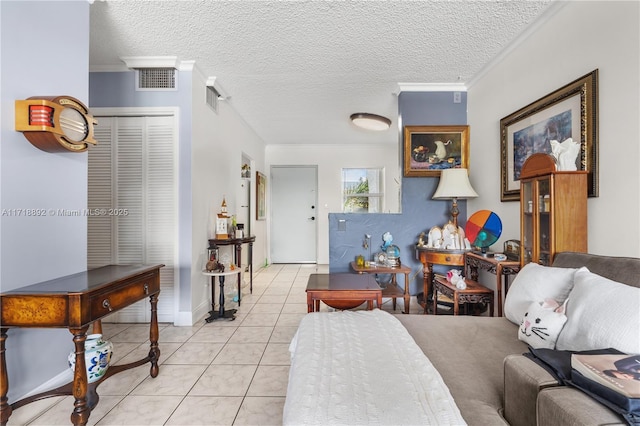 living room featuring ornamental molding, a textured ceiling, and light tile patterned floors