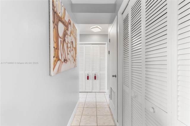 hall with light tile patterned floors