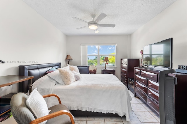 bedroom with a textured ceiling and ceiling fan