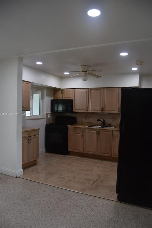 kitchen with black appliances, tasteful backsplash, a sink, and recessed lighting