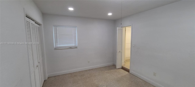 unfurnished bedroom featuring baseboards, a closet, and recessed lighting