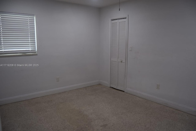 carpeted spare room with baseboards