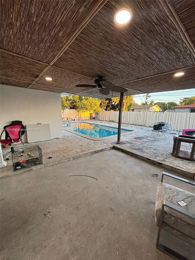 view of pool with a fenced in pool, a fenced backyard, ceiling fan, and a patio