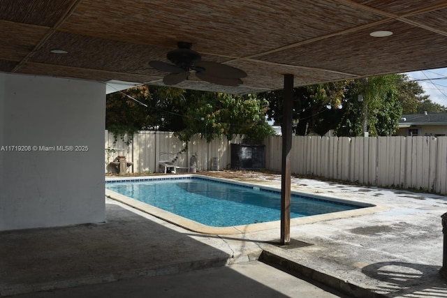 view of swimming pool with a patio area, a fenced backyard, and ceiling fan