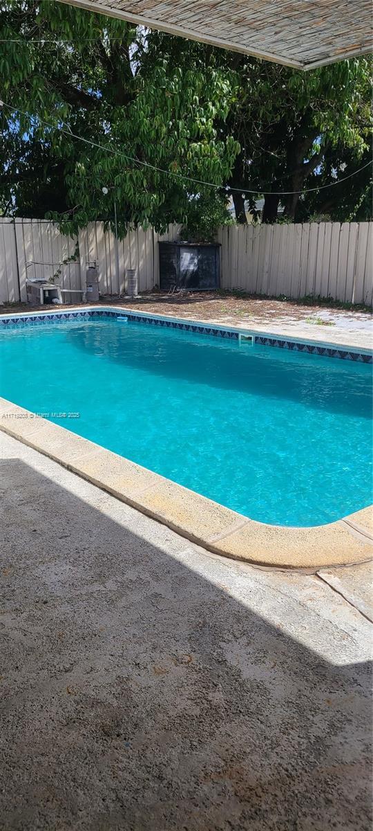 view of swimming pool featuring a fenced in pool and fence