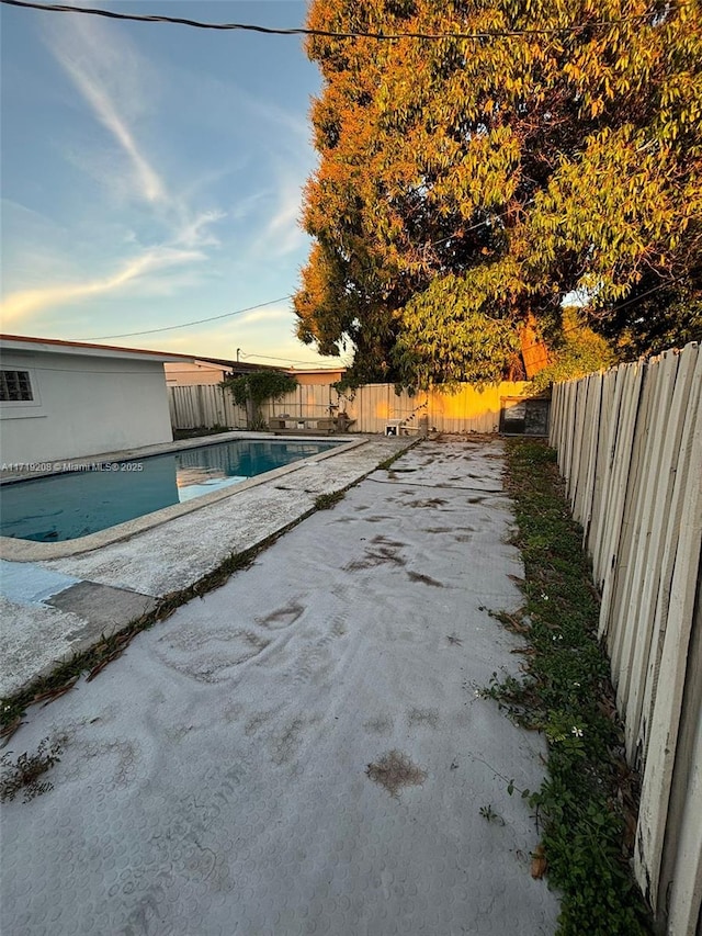 view of swimming pool with a fenced in pool and a fenced backyard