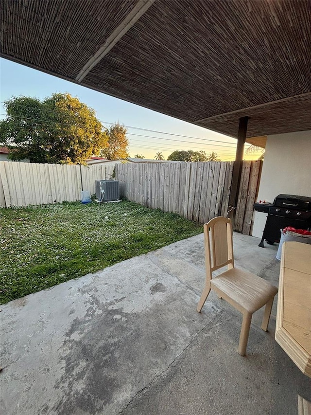 view of patio / terrace with a fenced backyard and central air condition unit