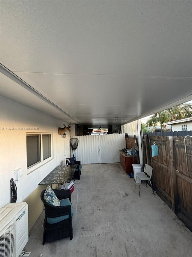 view of patio with ac unit and fence