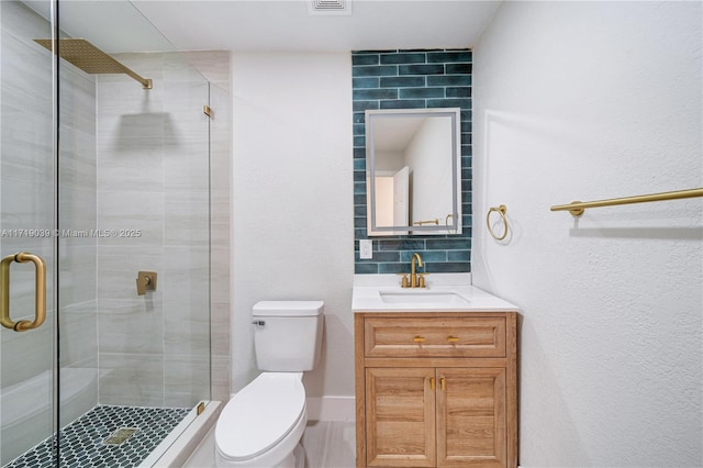 bathroom with decorative backsplash, vanity, walk in shower, and toilet