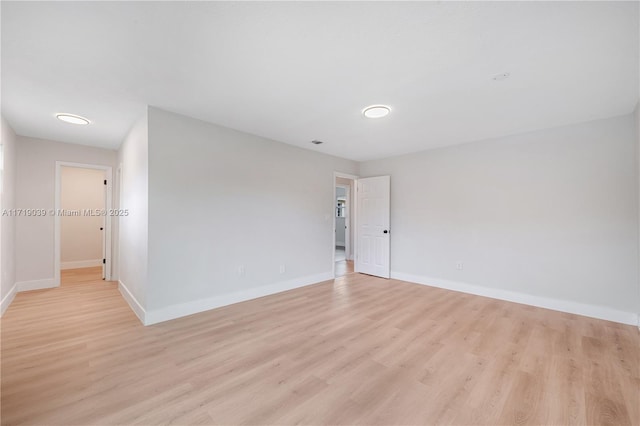 spare room with light hardwood / wood-style flooring