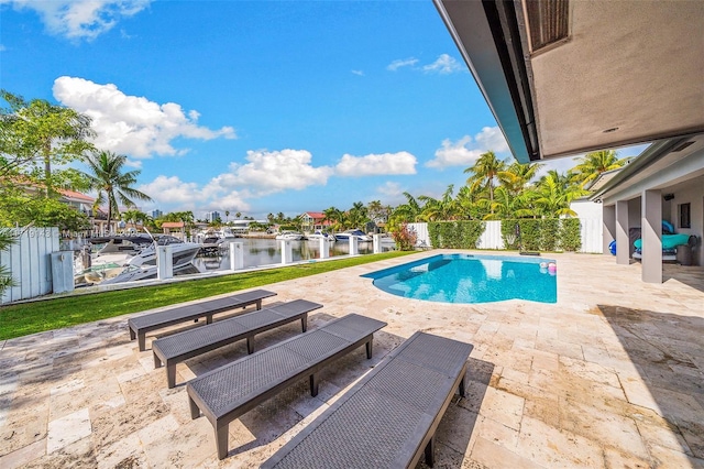 view of pool with a water view and a patio area