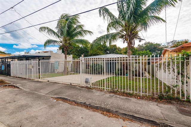 view of gate with a lawn