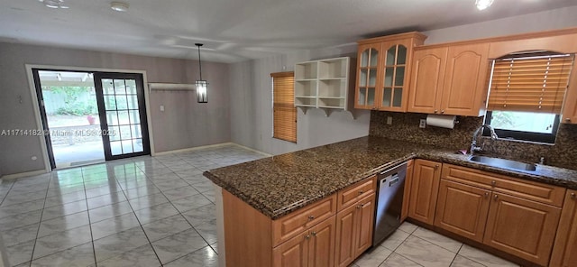 kitchen with dishwasher, decorative light fixtures, dark stone counters, sink, and light tile patterned floors