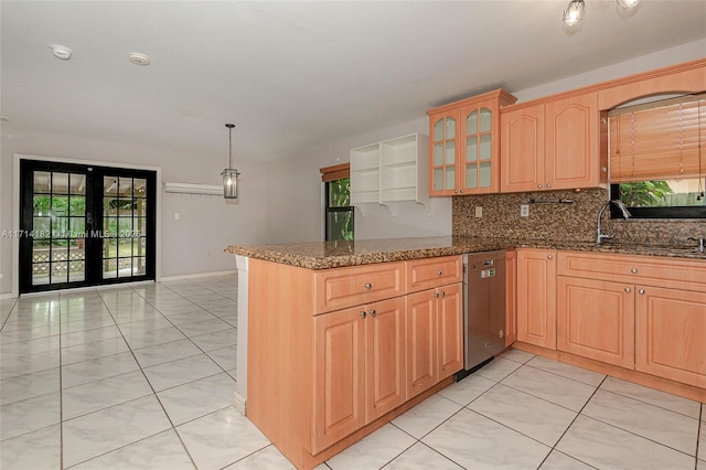 kitchen with french doors, tasteful backsplash, dark stone countertops, kitchen peninsula, and dishwasher