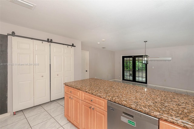 kitchen with light brown cabinetry, dishwasher, light tile patterned floors, light stone counters, and a barn door