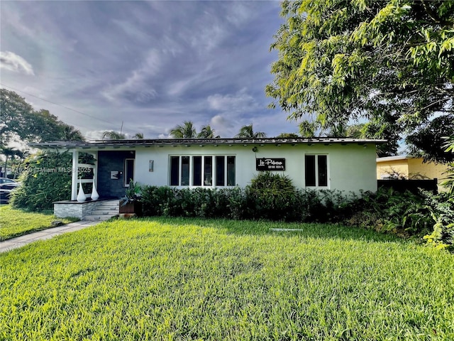 ranch-style house with a front lawn