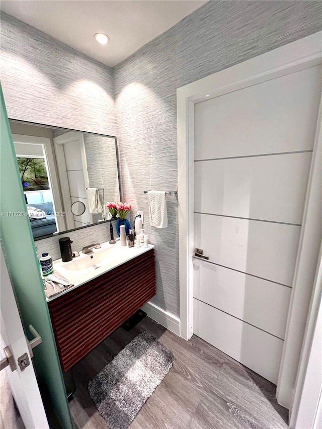 bathroom featuring vanity and hardwood / wood-style flooring