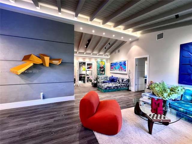 living room with wood-type flooring and vaulted ceiling with beams