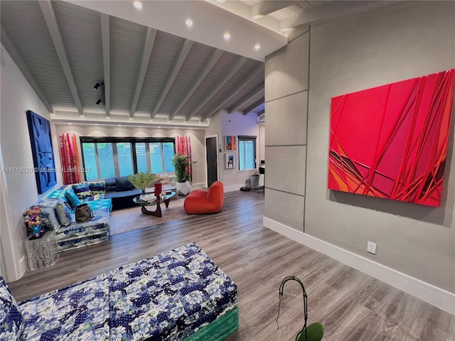 living room featuring vaulted ceiling with beams, hardwood / wood-style floors, and wooden ceiling