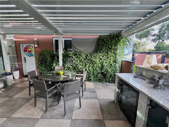 view of patio / terrace with beverage cooler and an outdoor bar