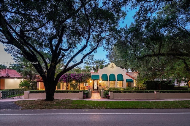 mediterranean / spanish-style home with a lawn