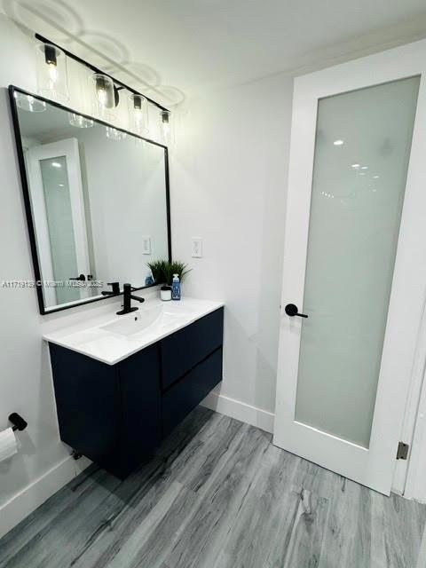 bathroom with hardwood / wood-style floors and vanity