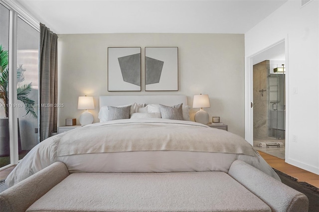 bedroom featuring wood-type flooring and ensuite bathroom