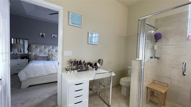 bathroom with a shower with door, tile patterned floors, and toilet