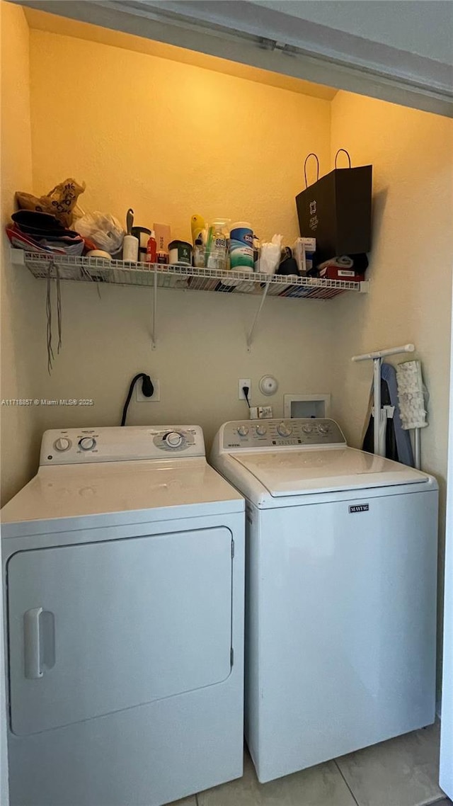 clothes washing area featuring washer and clothes dryer