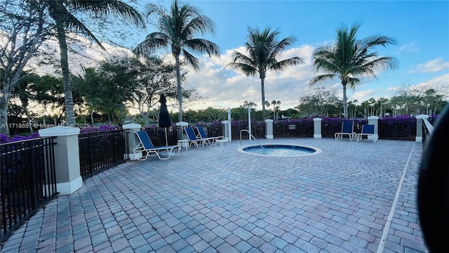 view of swimming pool featuring a community hot tub and a patio area