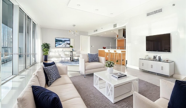 495 Brickell Ave Unit 2301, Miami, FL 33131 - living room featuring a chandelier, baseboards, and light tile patterned flooring