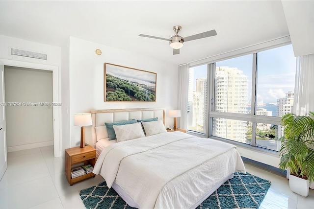 495 Brickell Ave Unit 2301, Miami, FL 33131 - bedroom featuring multiple windows, tile patterned flooring, a view of city, and baseboards
