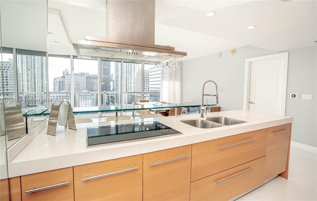 495 Brickell Ave Unit 2301, Miami, FL 33131 - kitchen featuring a sink, black electric stovetop, island exhaust hood, light countertops, and modern cabinets
