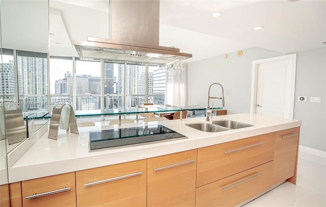 kitchen featuring island range hood, black electric stovetop, light tile patterned floors, and sink