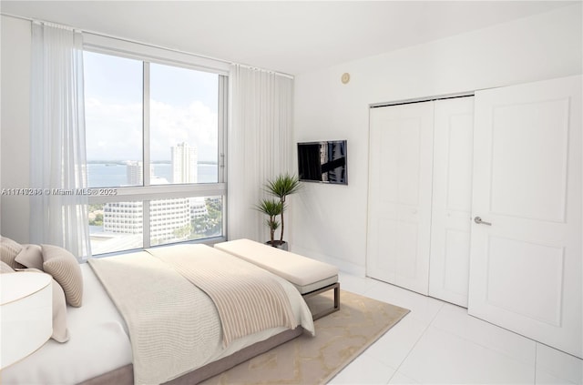 bedroom featuring a closet and light tile patterned floors