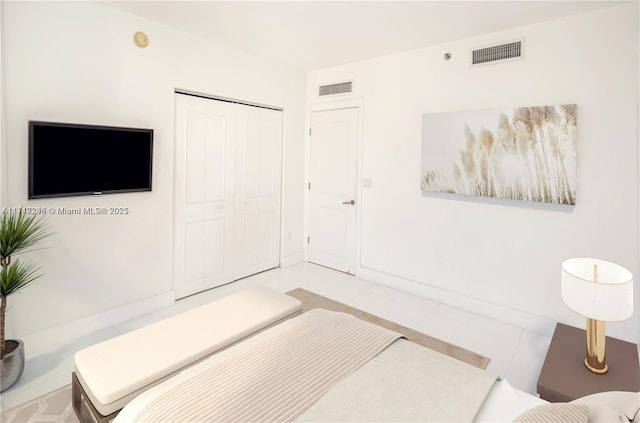 tiled bedroom featuring a closet