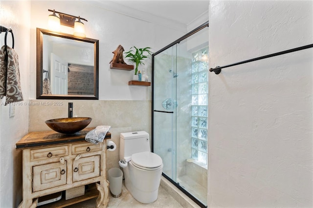 bathroom featuring walk in shower, vanity, tile walls, toilet, and crown molding